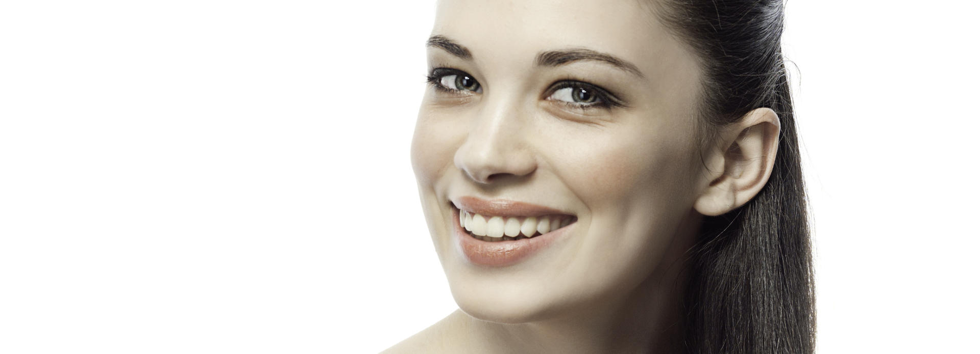 Face of a happy young woman with flowless skin after facial peel.