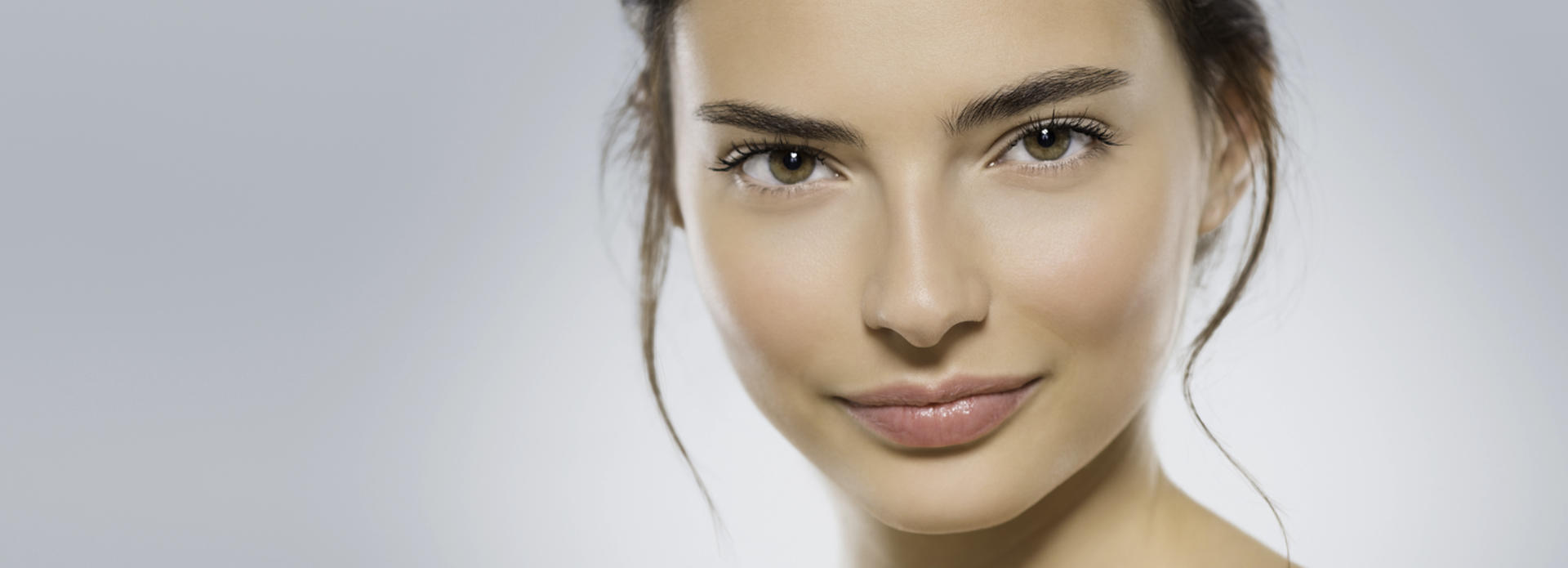 Face of a young-looking woman after facial rejuvenation treatment.