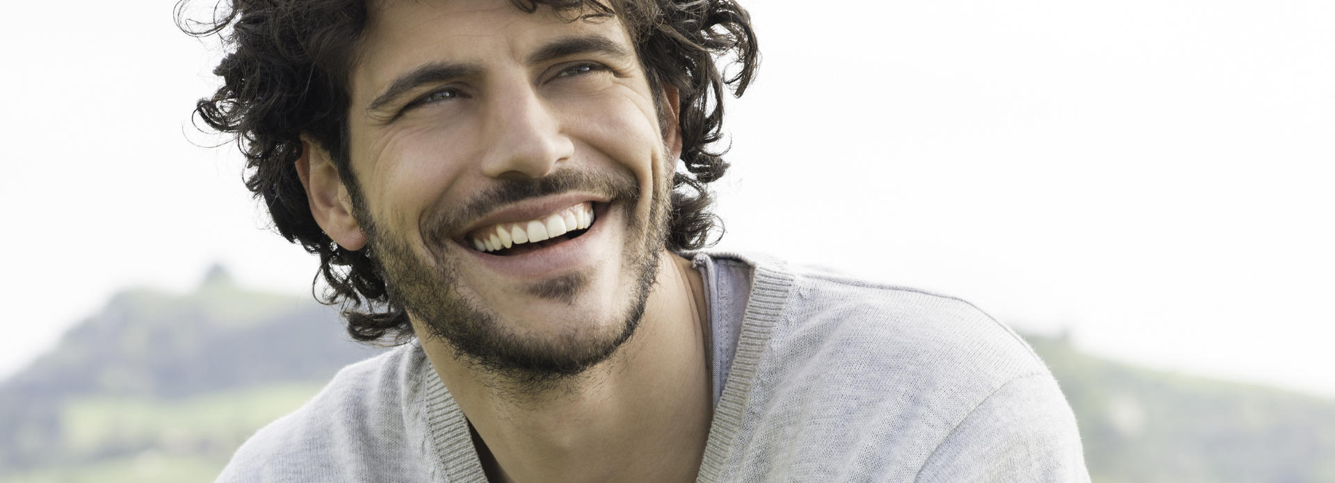 smiling handsome man with curly hair