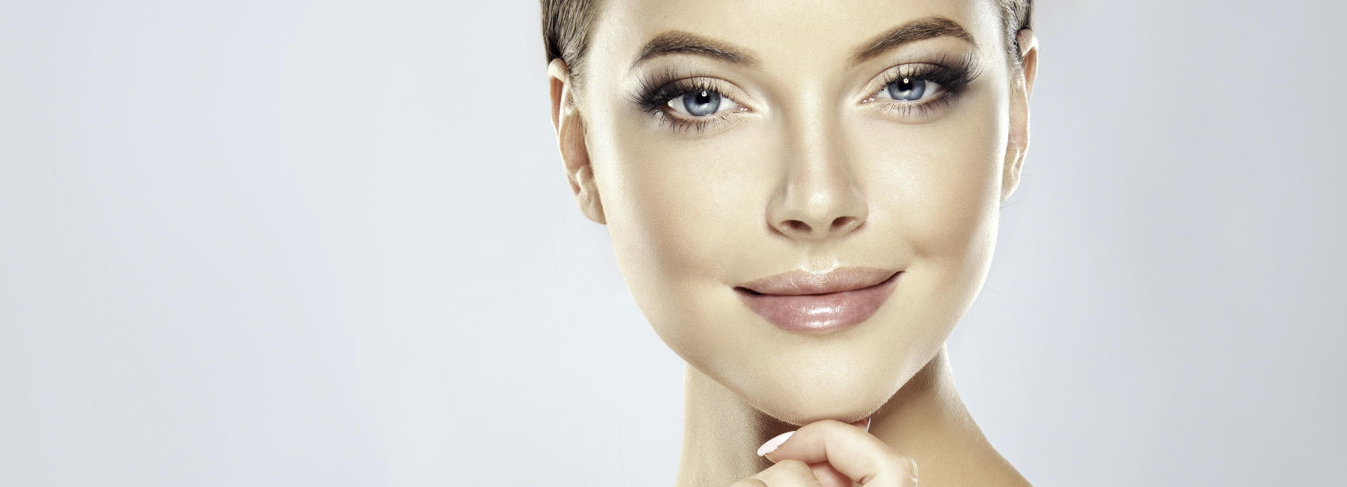 Face of a young-looking woman after cosmetic facial filler treatment.