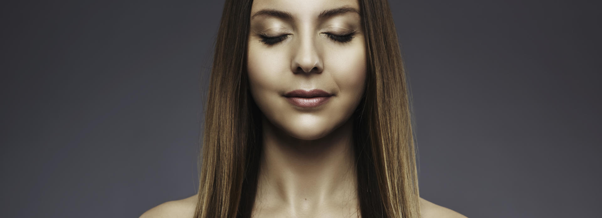 Face of a young-looking woman after cosmetic facial filler treatment.