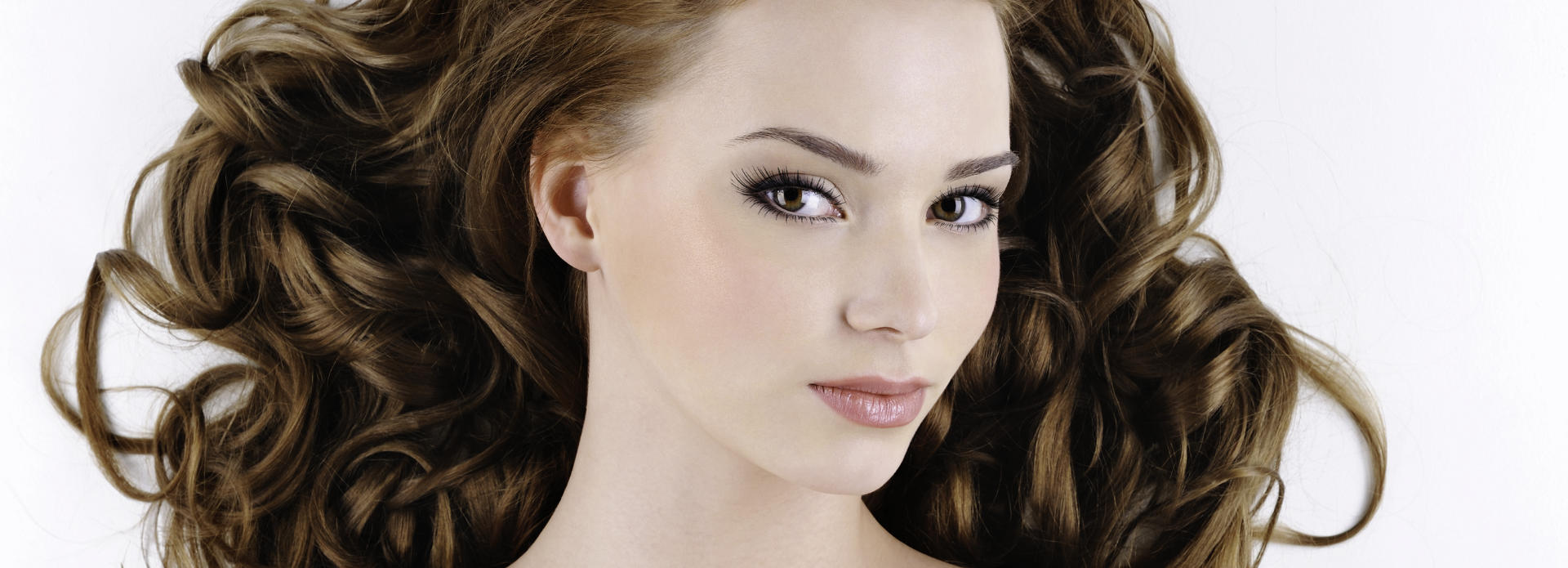 Face of a young-looking woman after cosmetic facial filler treatment.