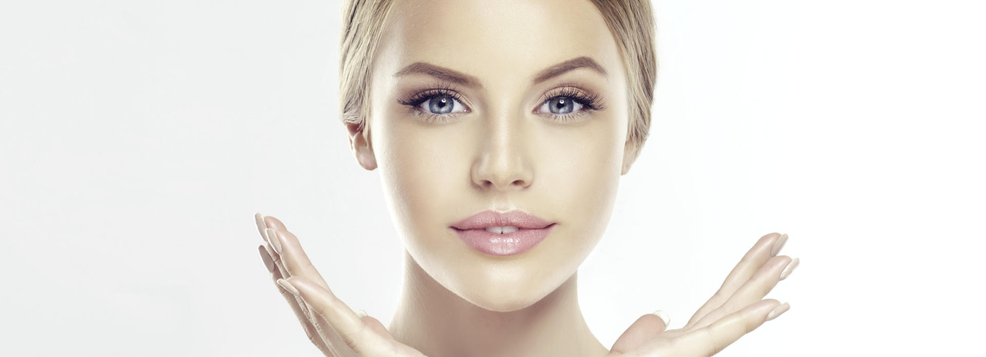 Face of a young-looking woman after cosmetic facial filler treatment.