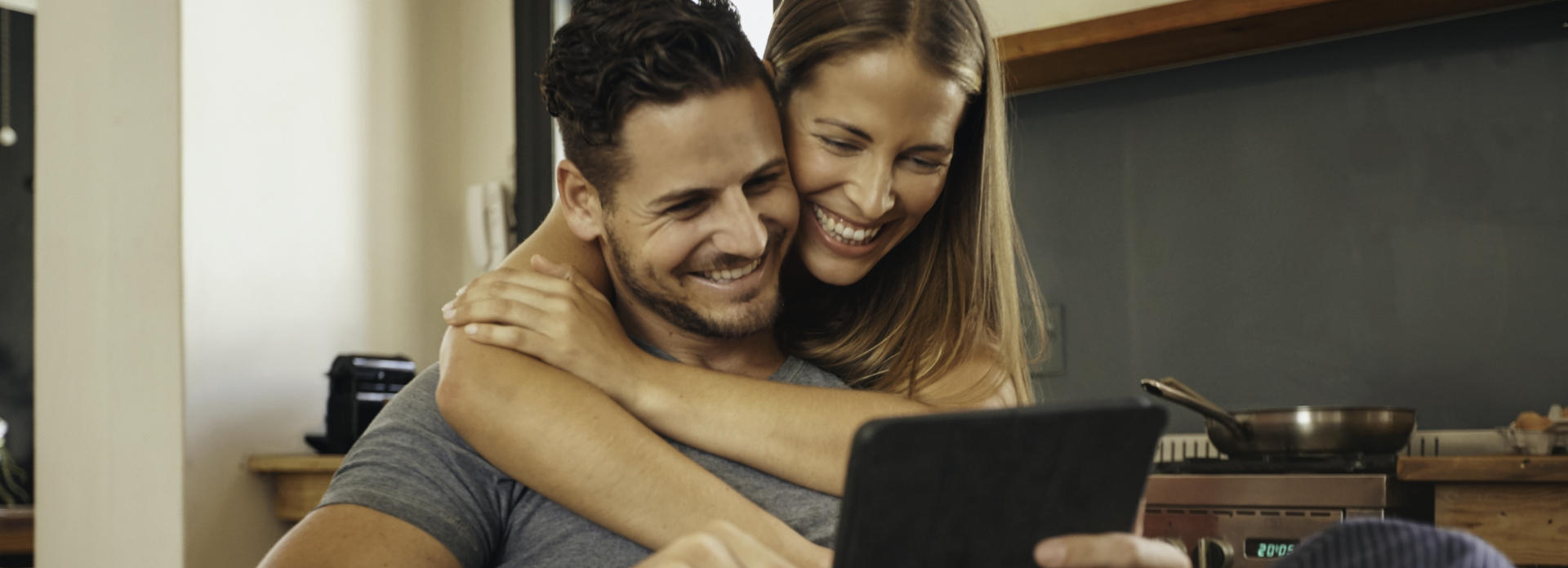 happy couple looks at the tablet