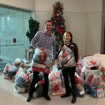 people are holding christmas gifts