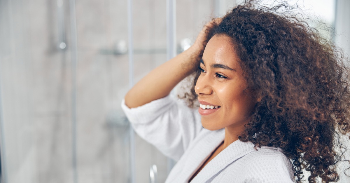 Woman touching her scalp