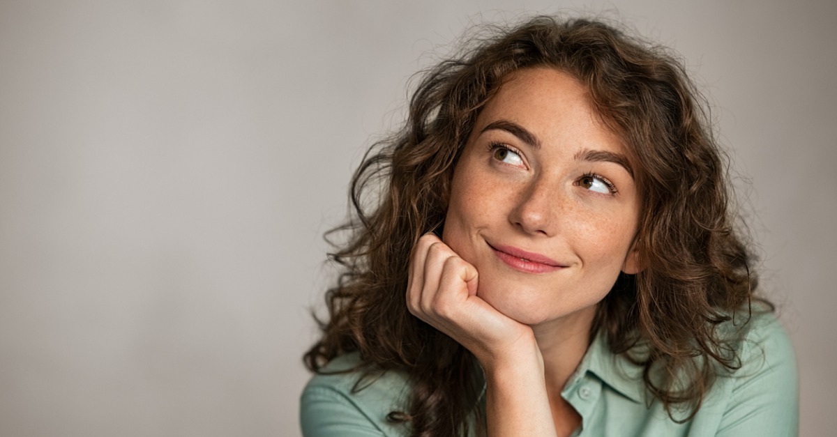 positive young woman thinking