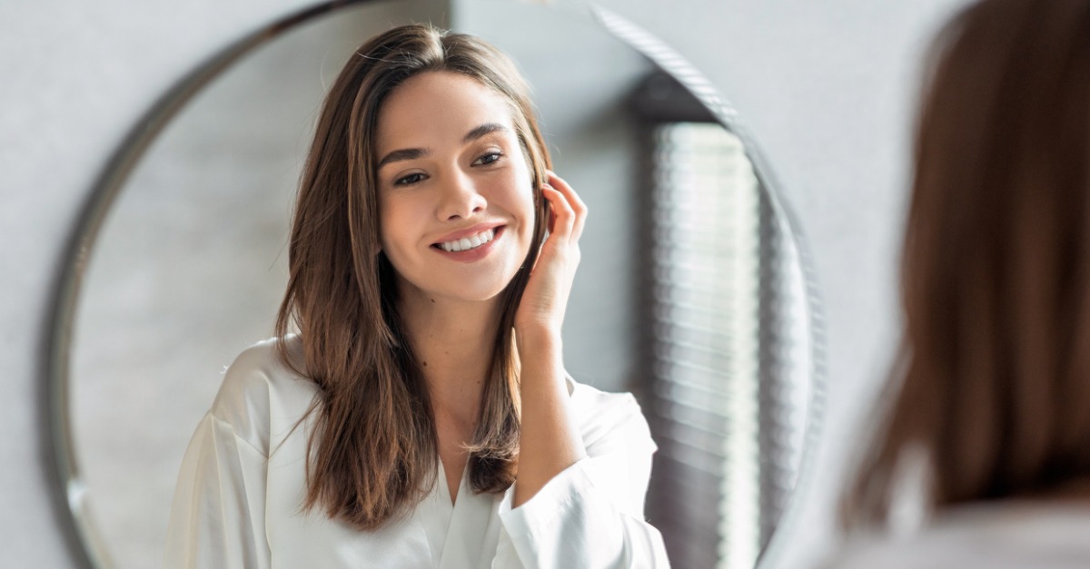 Woman appreciating skin in mirror